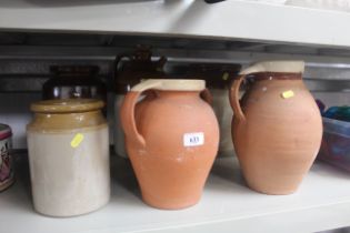A collection of stoneware bottles and jars