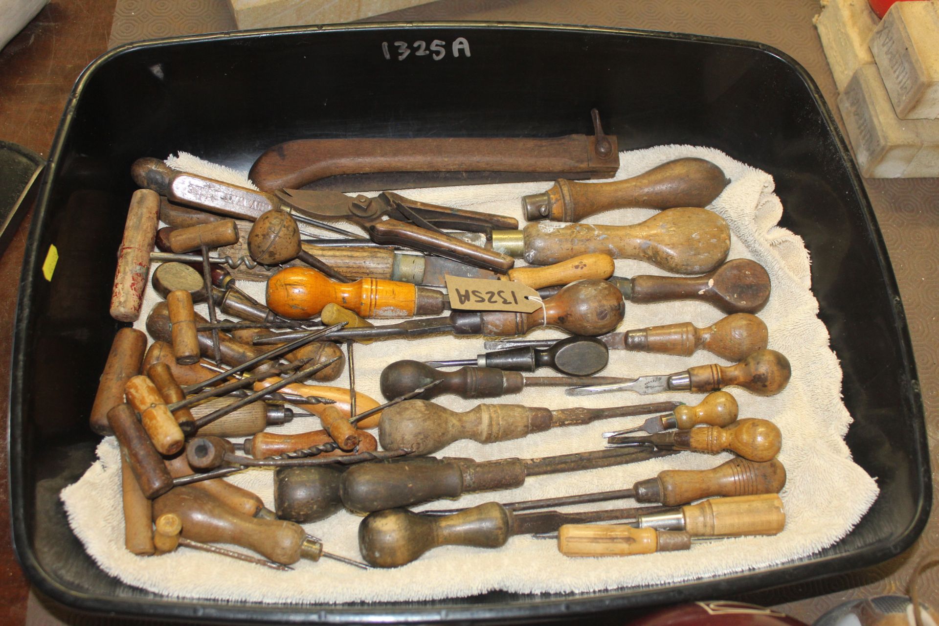A quantity of various wooden handled hand tools in