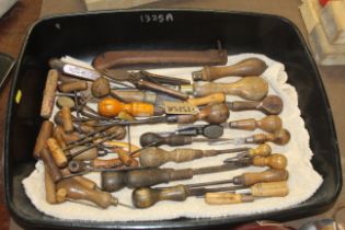 A quantity of various wooden handled hand tools in