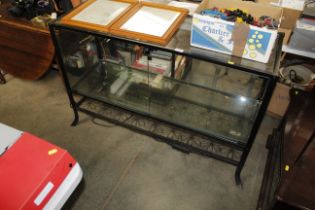 A black metal framed display cabinet