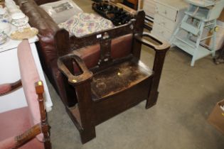 An oak hall bench with under seat storage