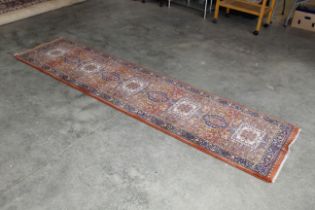 An approx. 9'4" x 2'4" pattern rug