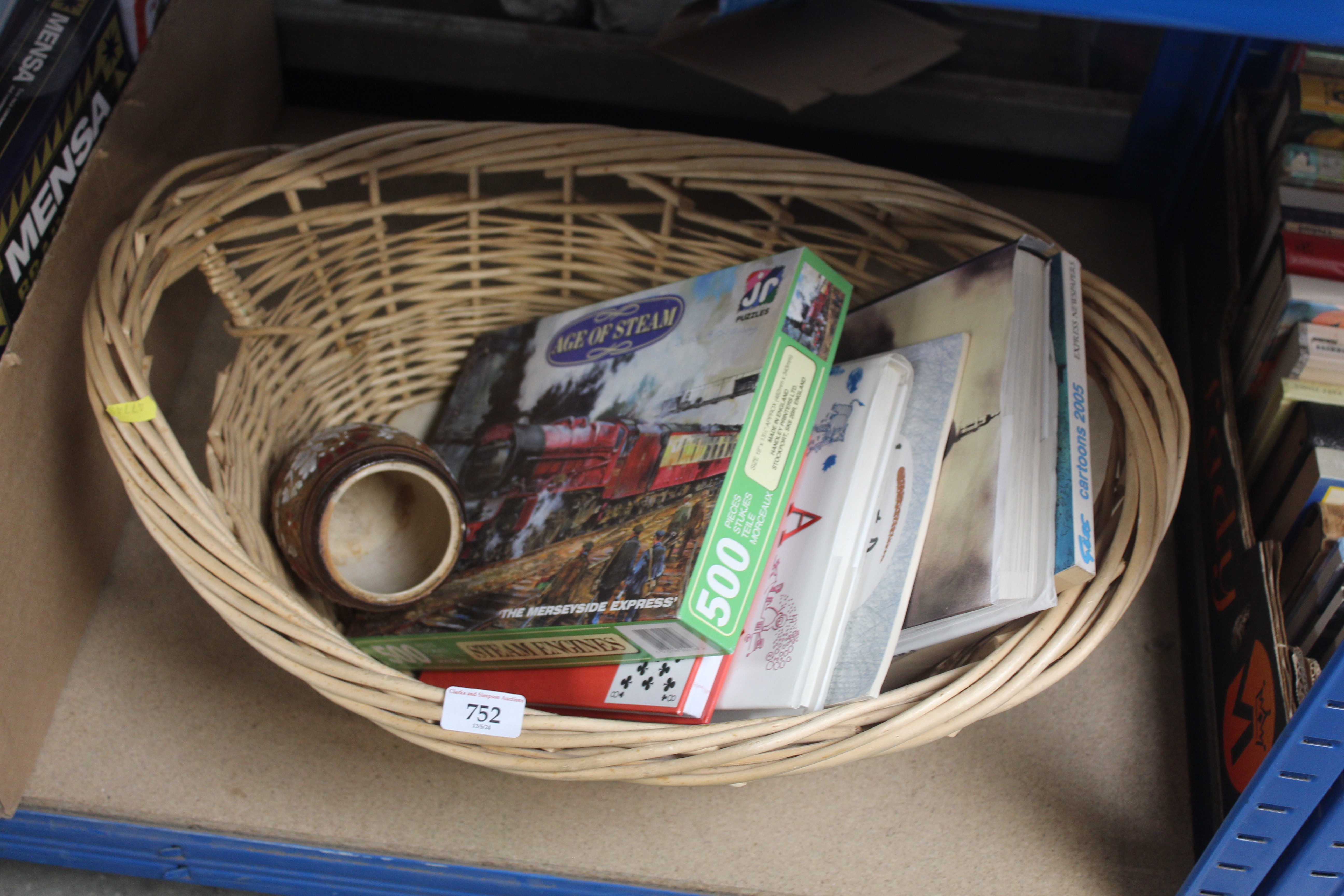 A basket containing books; a puzzle and a Royal Do