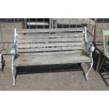 An ornate white painted garden bench