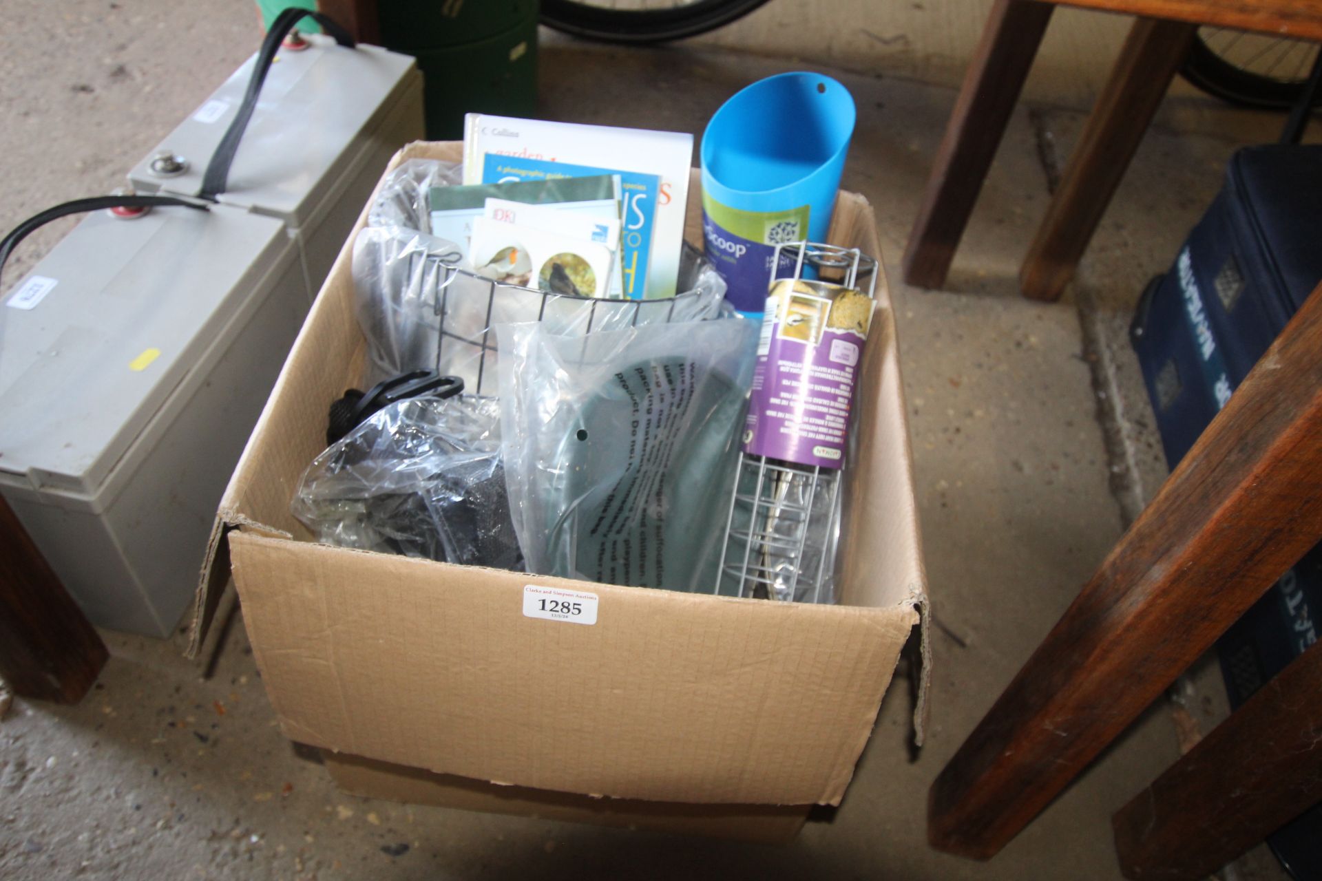 A box containing a quantity of items including bir