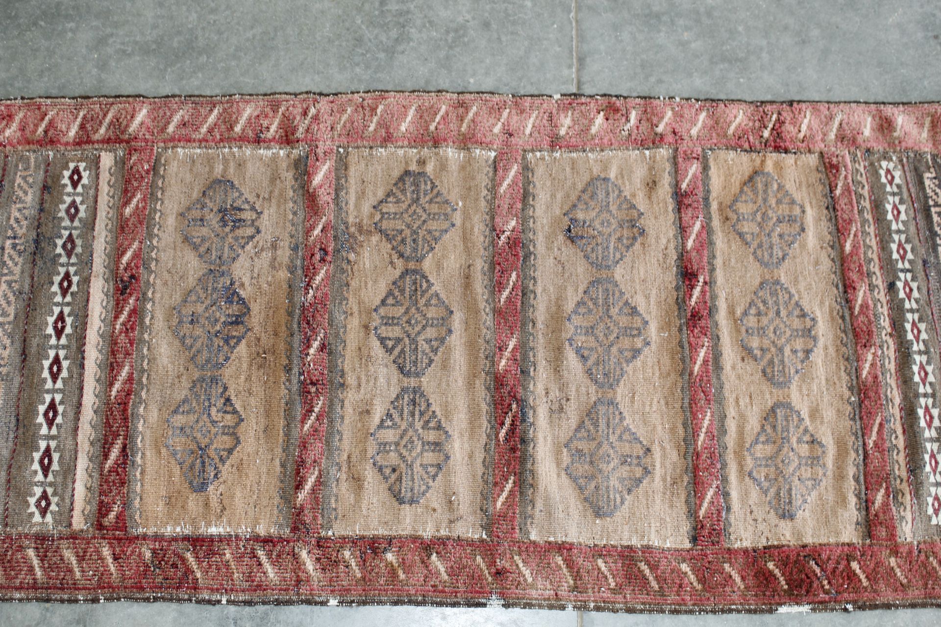 An approx. 5'1" x 2'2" Eastern red pattern rug - Image 2 of 5