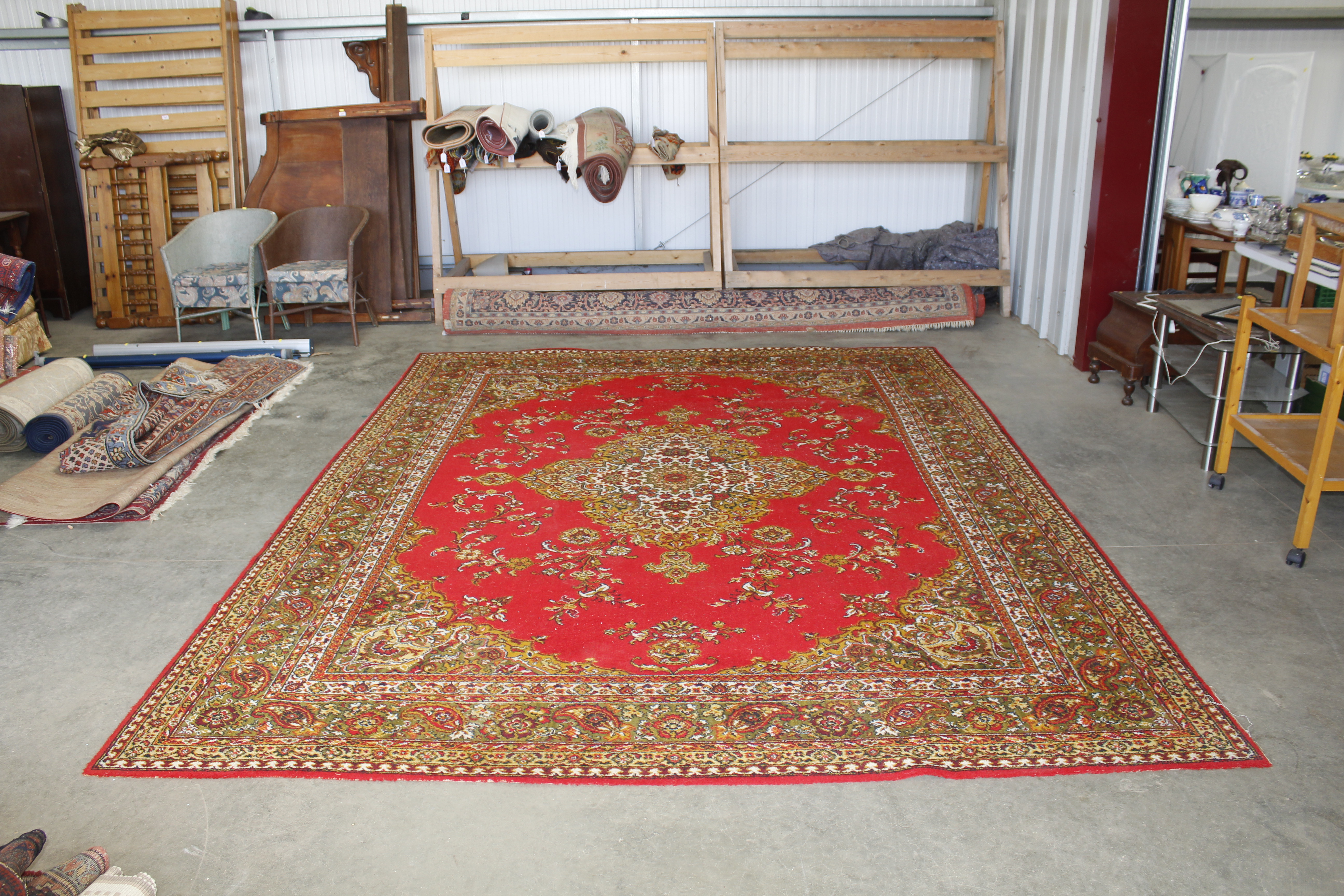 An approx. 12' x 9' red patterned rug AF