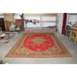 An approx. 12' x 9' red patterned rug AF