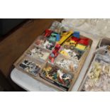 A box containing various metal and plastic farm an