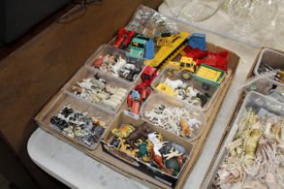 A box containing various metal and plastic farm an