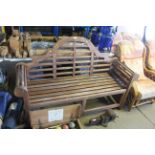 A Lutyens style hardwood three seater garden bench