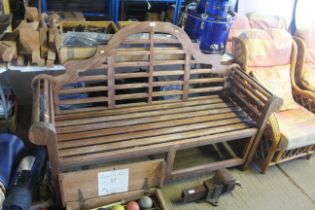 A Lutyens style hardwood three seater garden bench