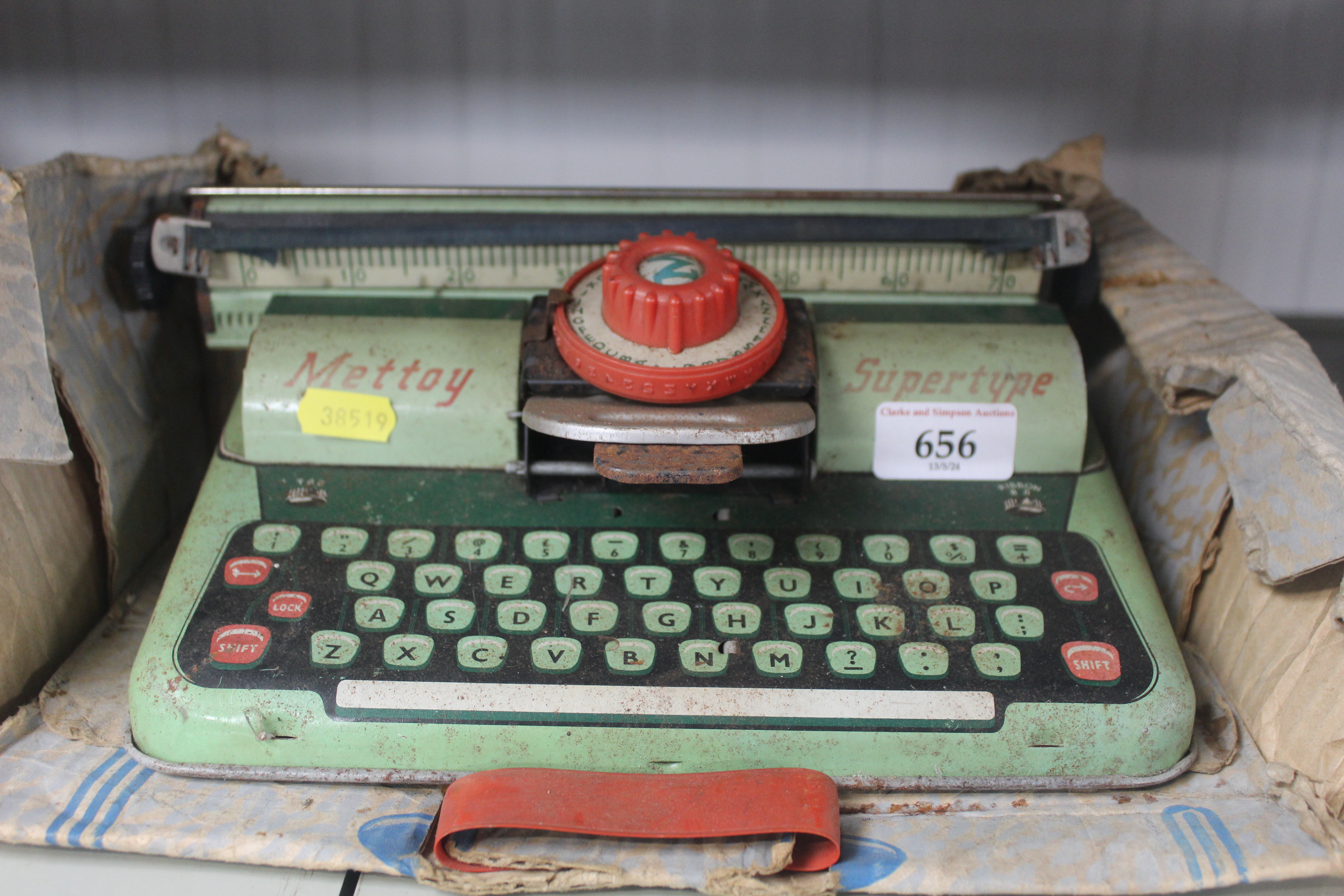 A vintage tin plate toy typewriter