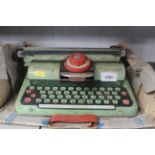 A vintage tin plate toy typewriter