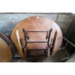 A large wooden circular folding events table appro