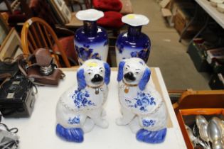 A pair of floral decorated blue and white vases an