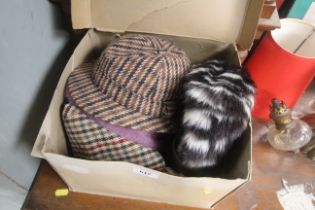 A hat box and contents of various hats