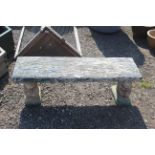 A painted concrete garden bench set to twin squirr