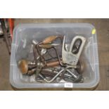 A box containing various hand braces, staple gun,