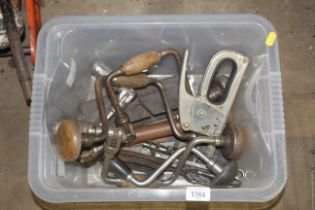 A box containing various hand braces, staple gun,
