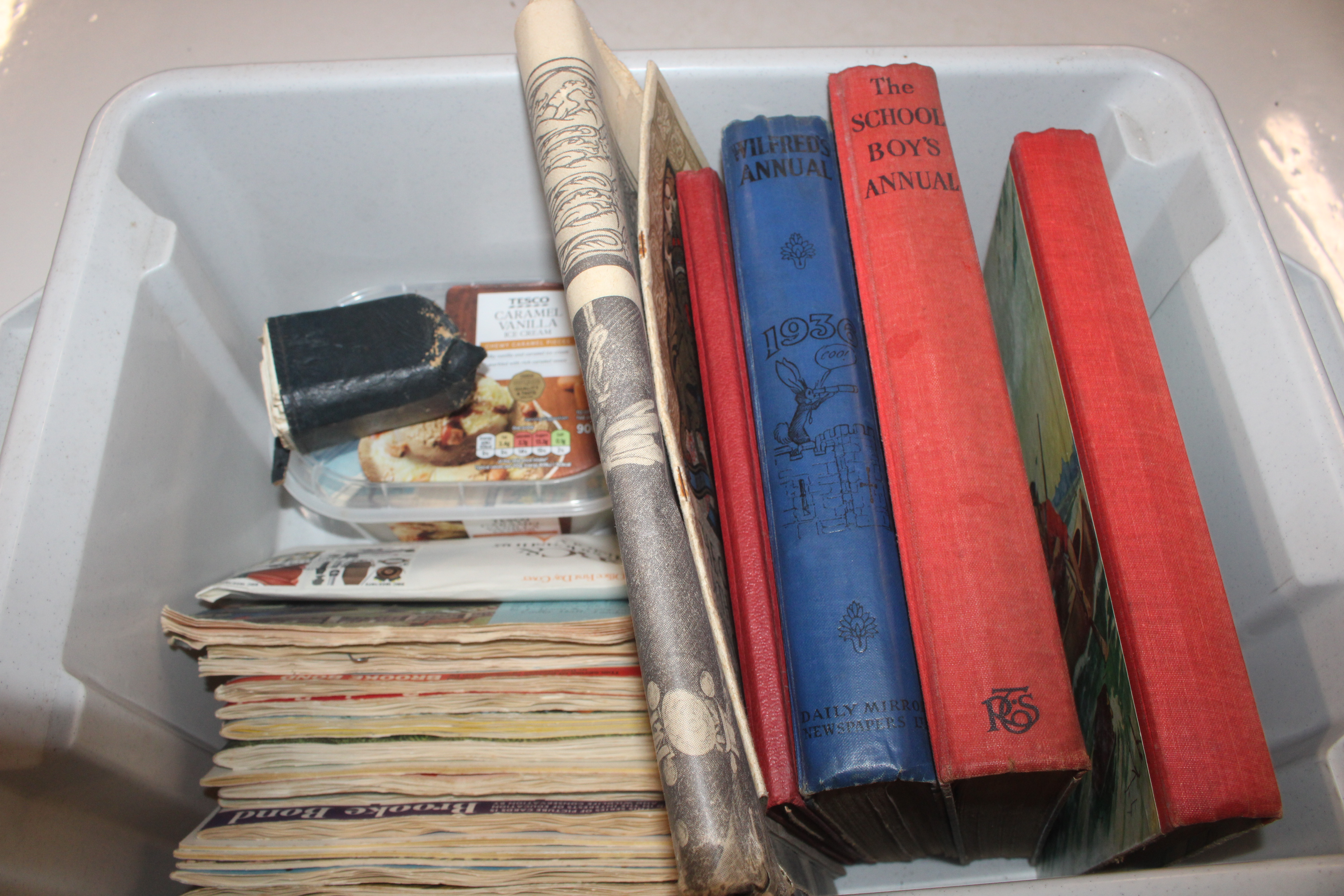 A box containing children's annuals, various ephem
