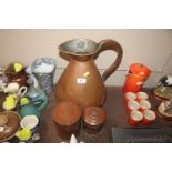 A large copper jug and two copper lidded pots