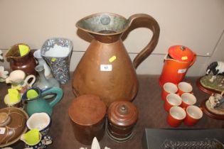 A large copper jug and two copper lidded pots