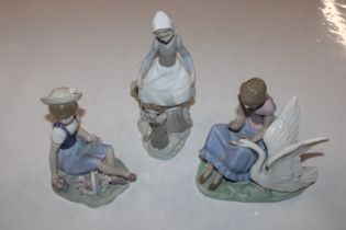A Nao figure, young girl with swan and two Lladro