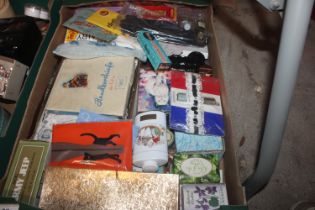 A box of various tins and advertising items