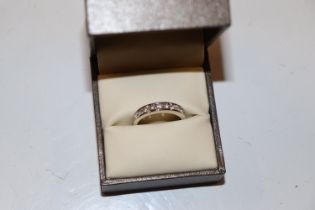 An 18ct white gold (marked rubbed) half eternity r