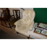 A Victorian button down upholstered armchair