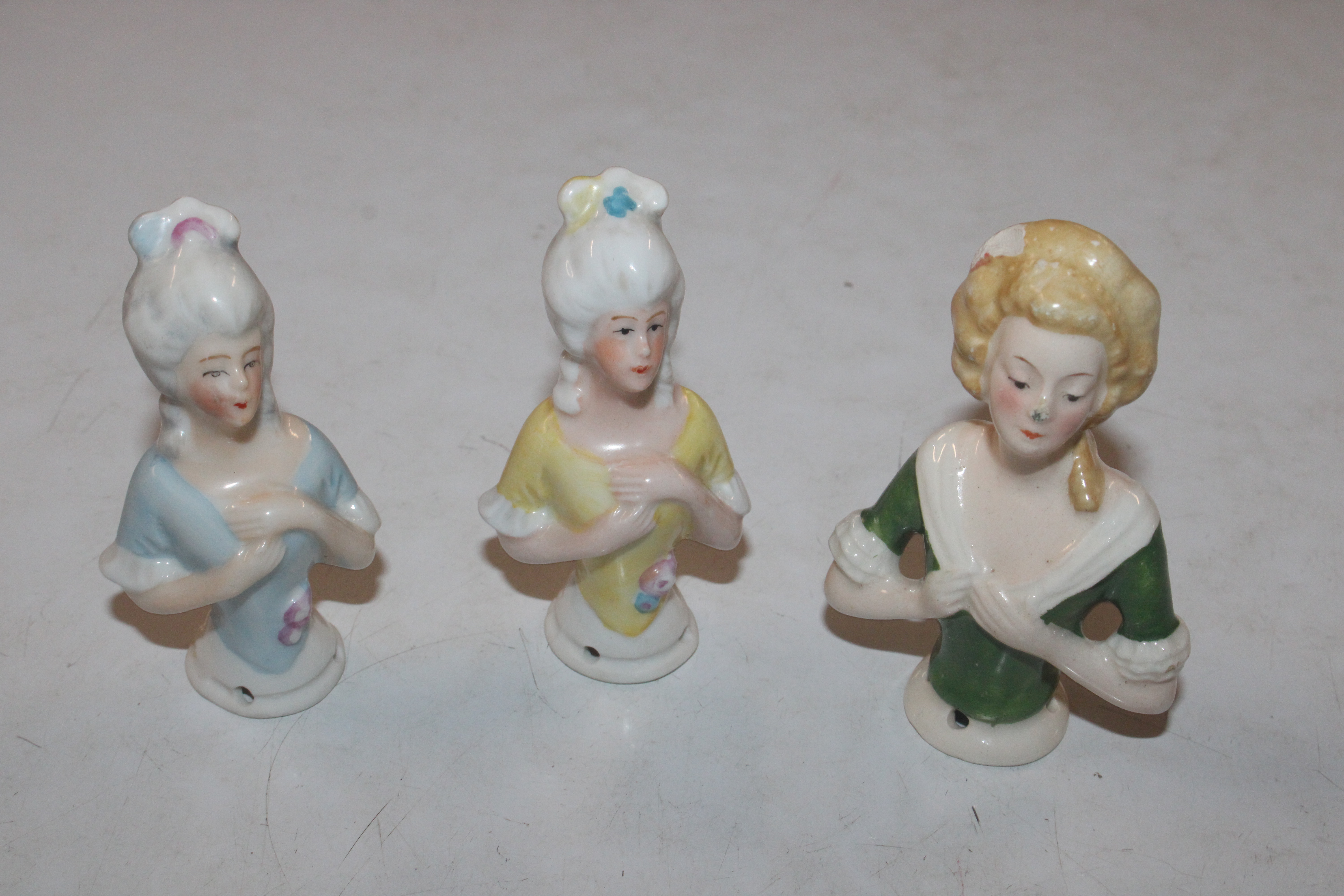 Three porcelain pin dolls