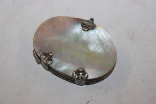 A white metal and mother of pearl magnifying glass