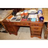 A mahogany twin pedestal writing desk with green l