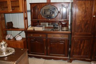 An early 20th Century mahogany and a mirrored back