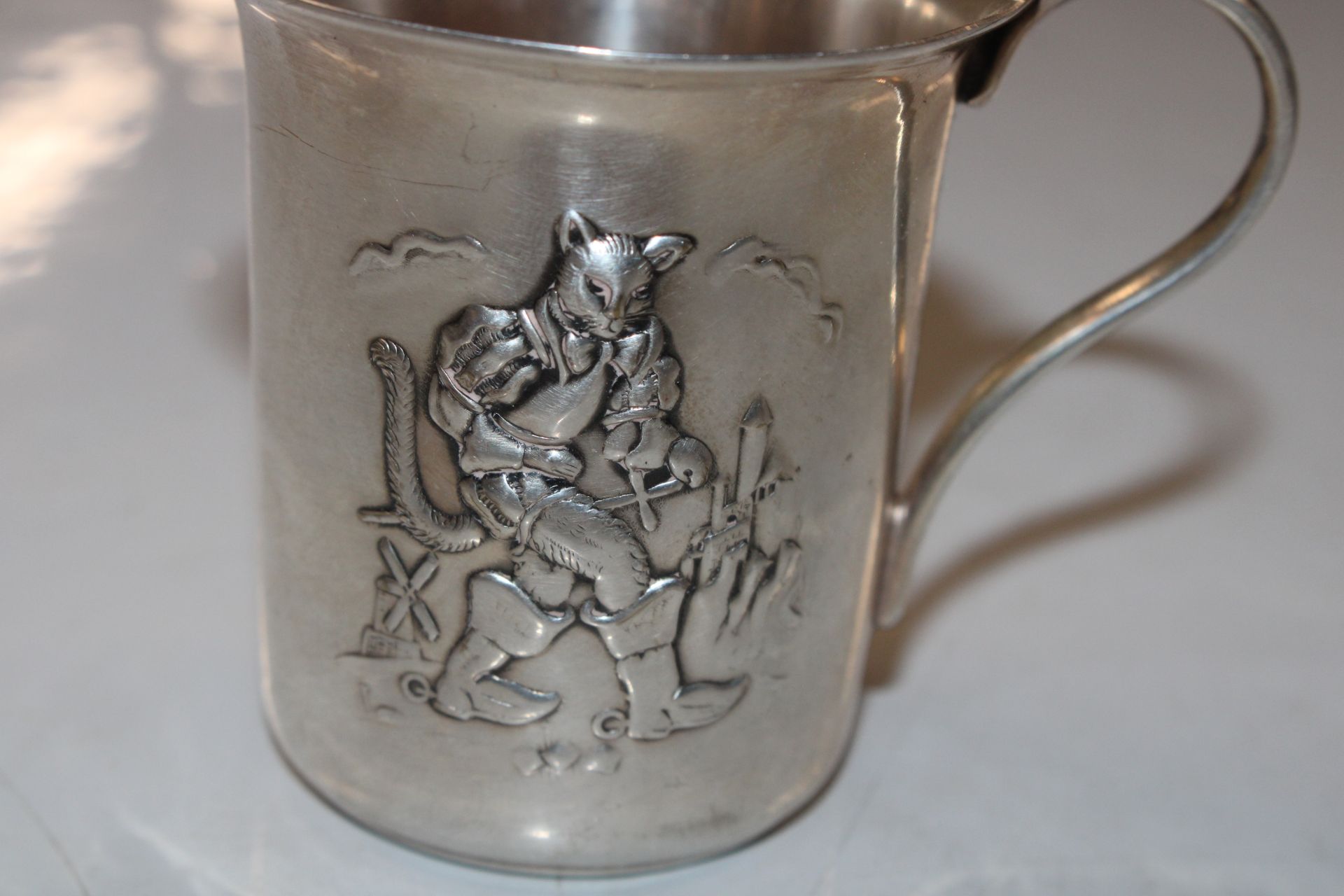 A white metal cup decorated with Puss-in Boots, ap - Image 2 of 4