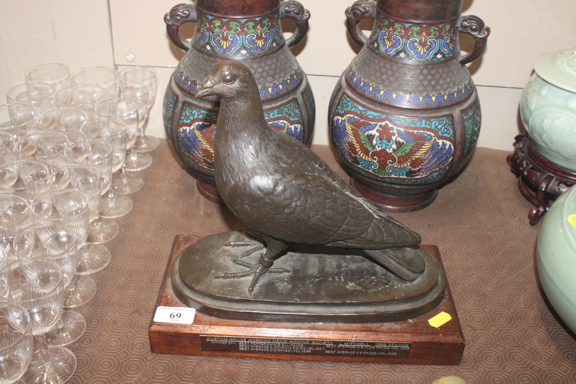 A bronzed figure of a racing pigeon, signed
