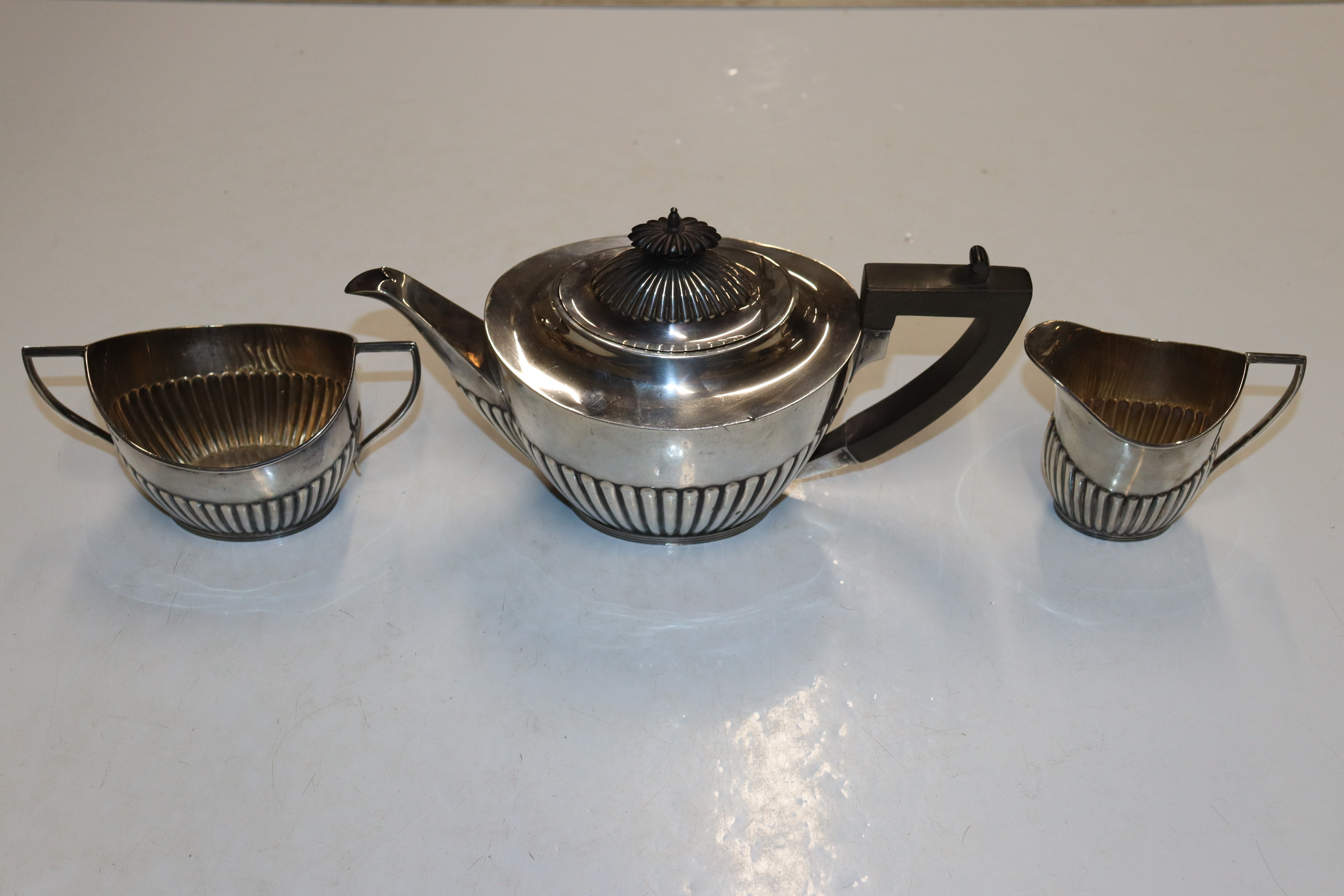A Mappin & Webb silver half fluted three piece tea set, approx. total weight 21oz (796gms)