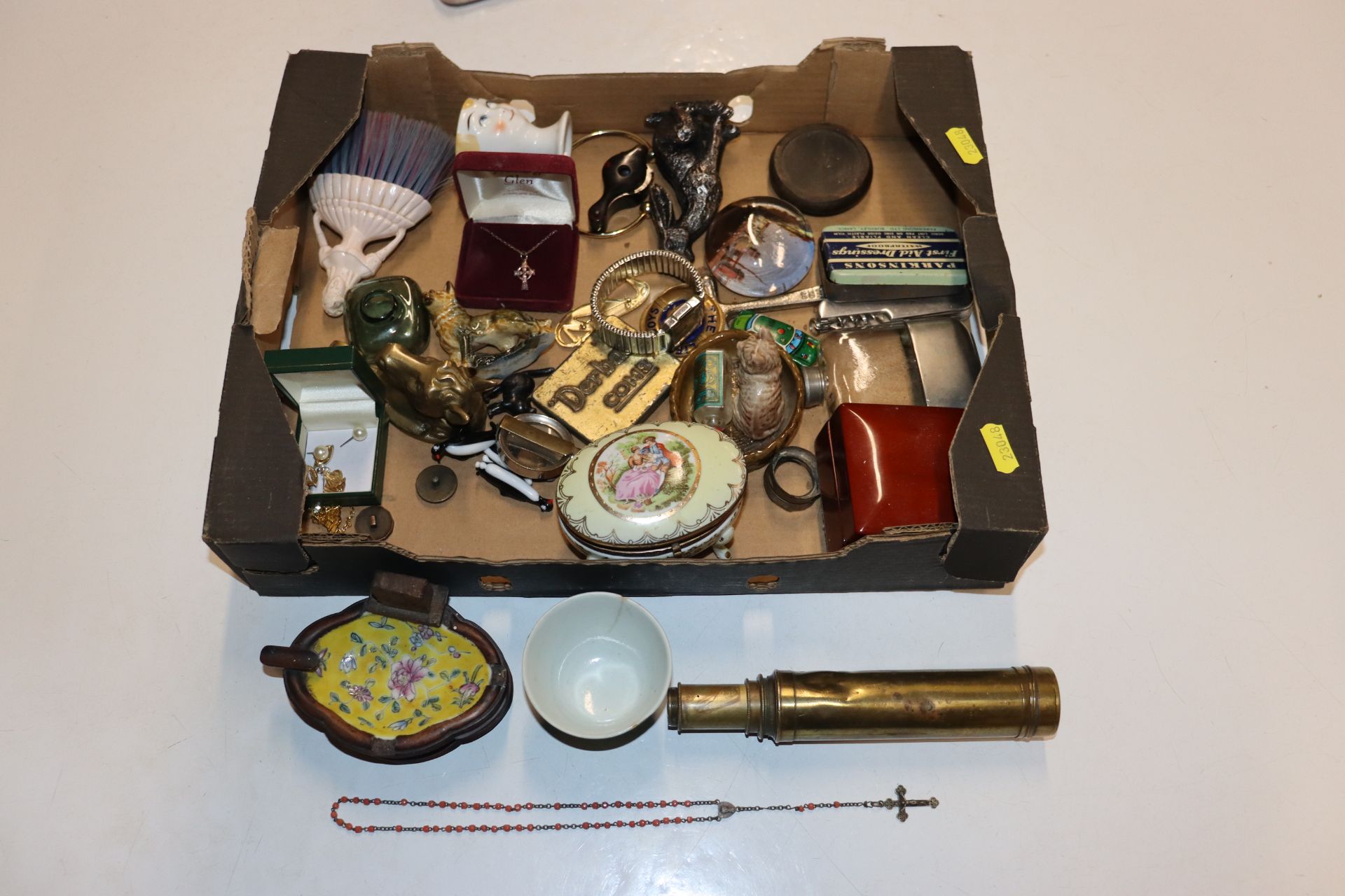 A box containing a brass telescope, various costum