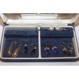 A blue jewellery box containing five pairs of Cave