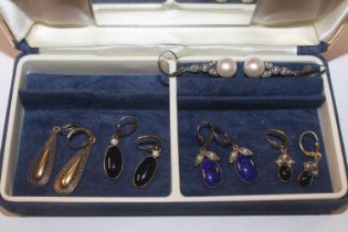 A blue jewellery box containing five pairs of Cave