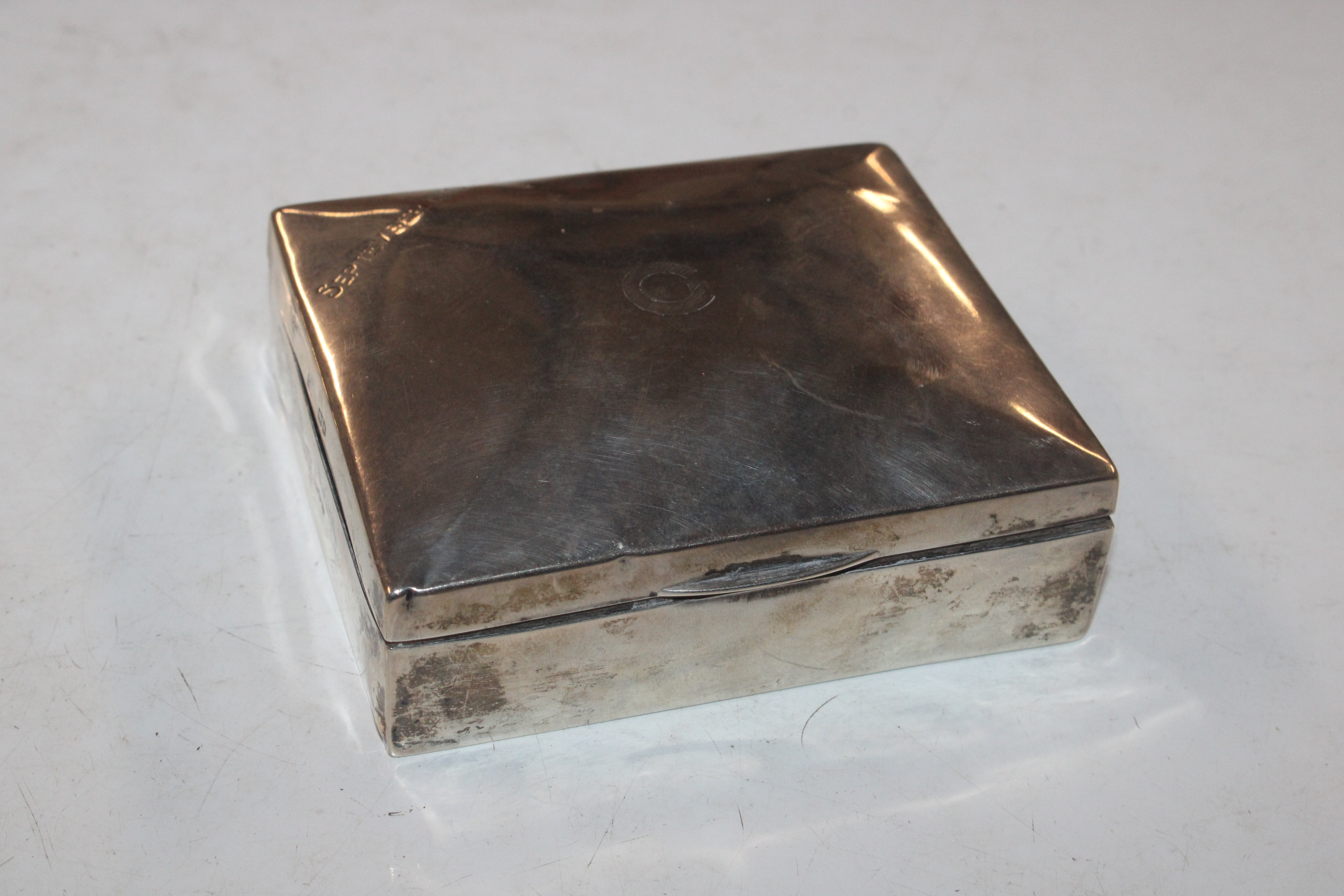 A Mappin & Webb silver cigarette box with wooden liner, engraved