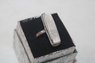 A silver ring set with unpolished crystal