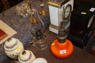 Two oil lamps with glass chimneys