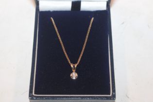 A 9ct gold and diamond set pendant, hung to a 9ct