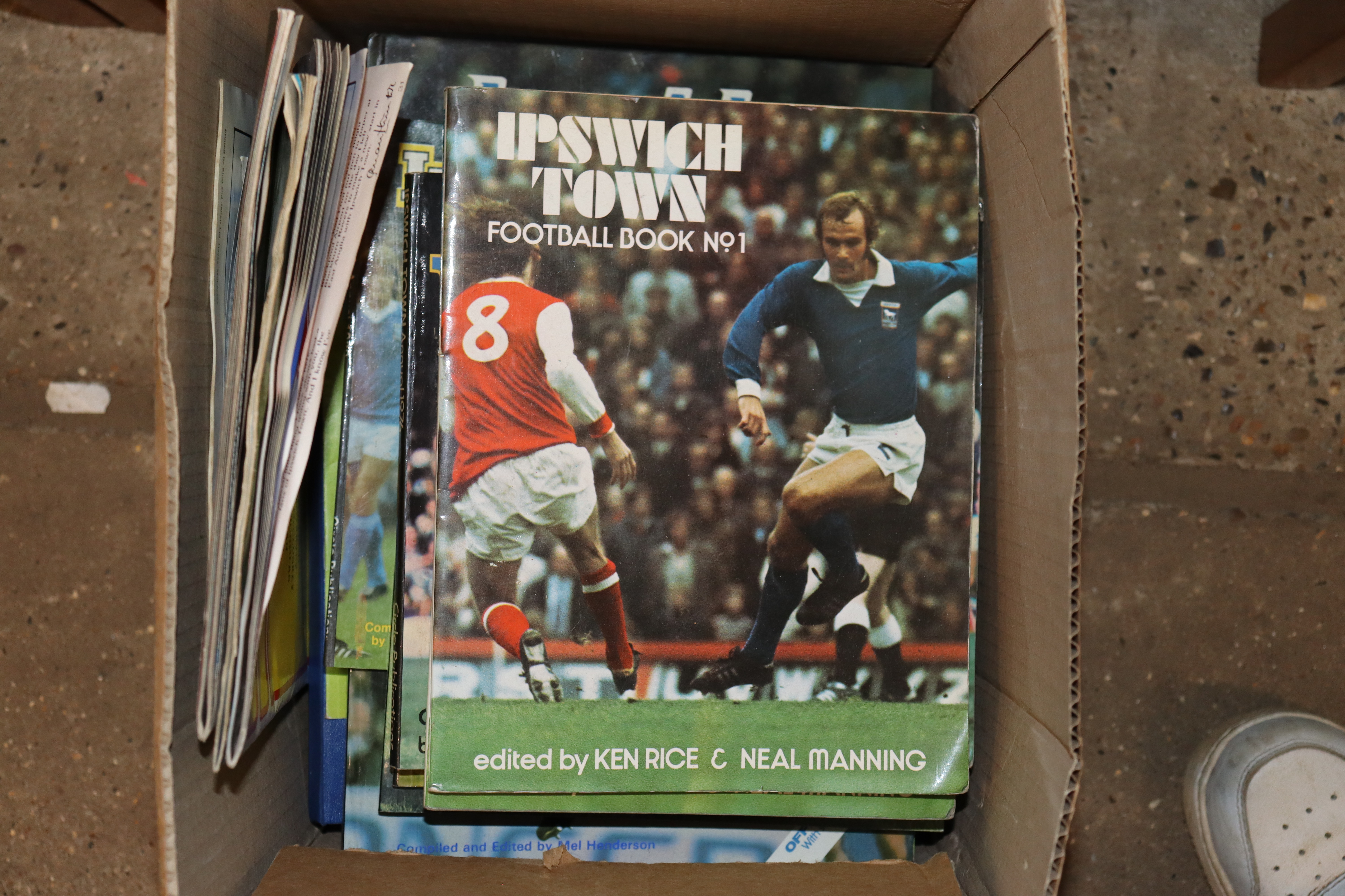 A box containing various Ipswich Town football pro