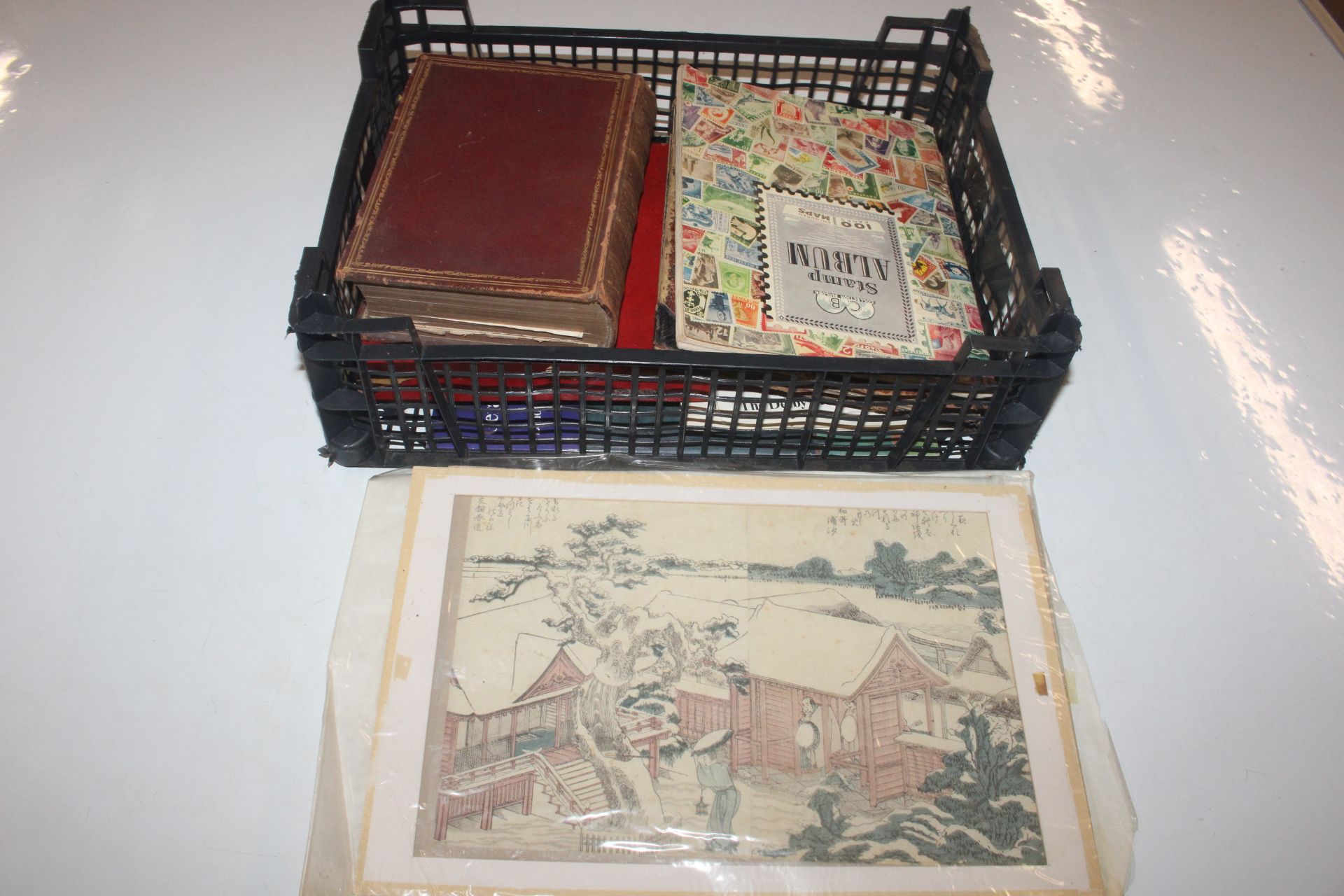 A box containing stamp album, various loose stamps