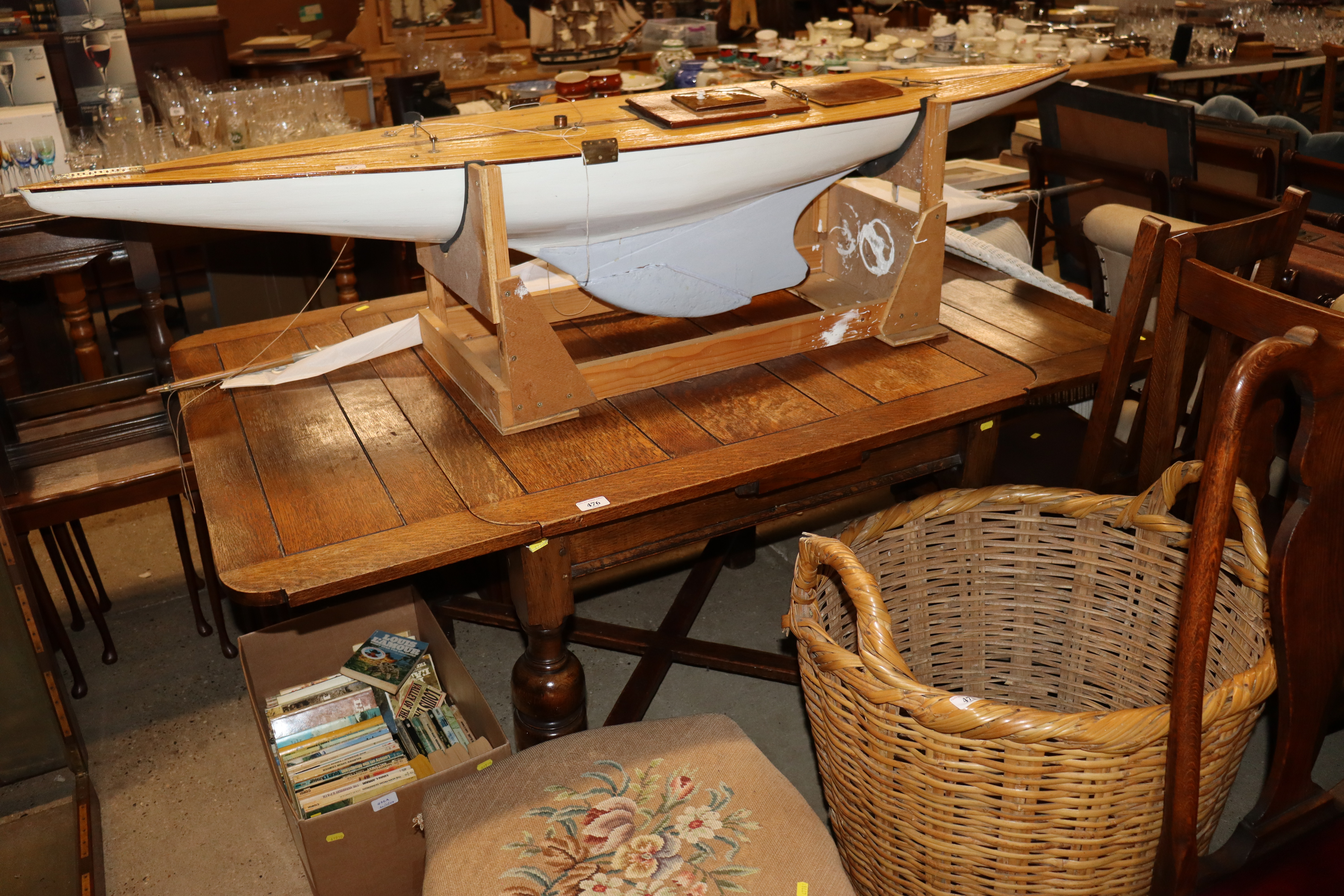 An oak draw leaf table with a set of four oak slat