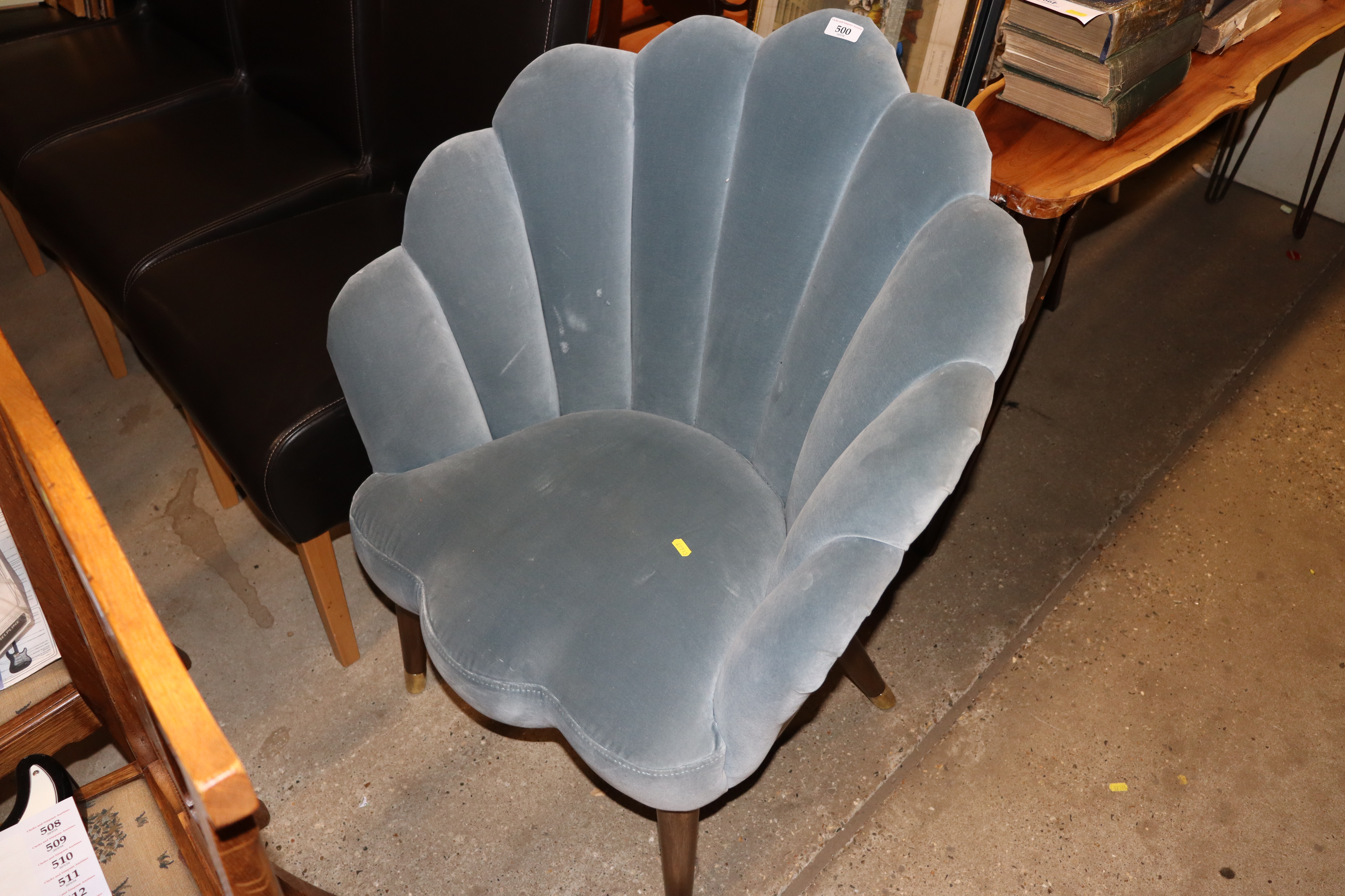 A blue upholstered shaped tub chair