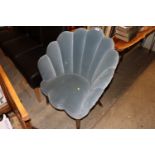 A blue upholstered shaped tub chair